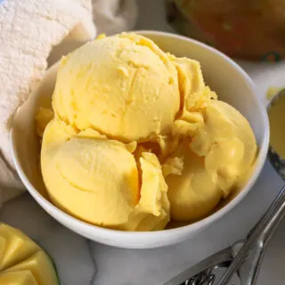 a white bowl of mango sorbet